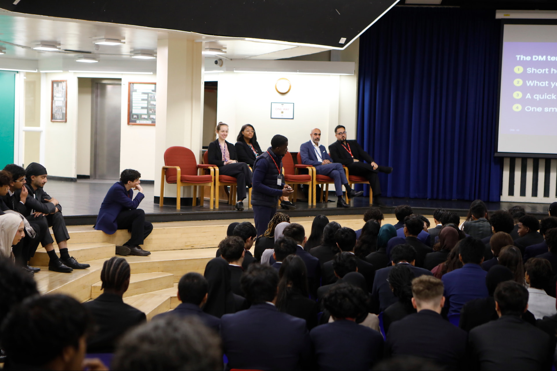 Amanor Recruitment presenting to students at a Heathland School assembly with a panel on stage